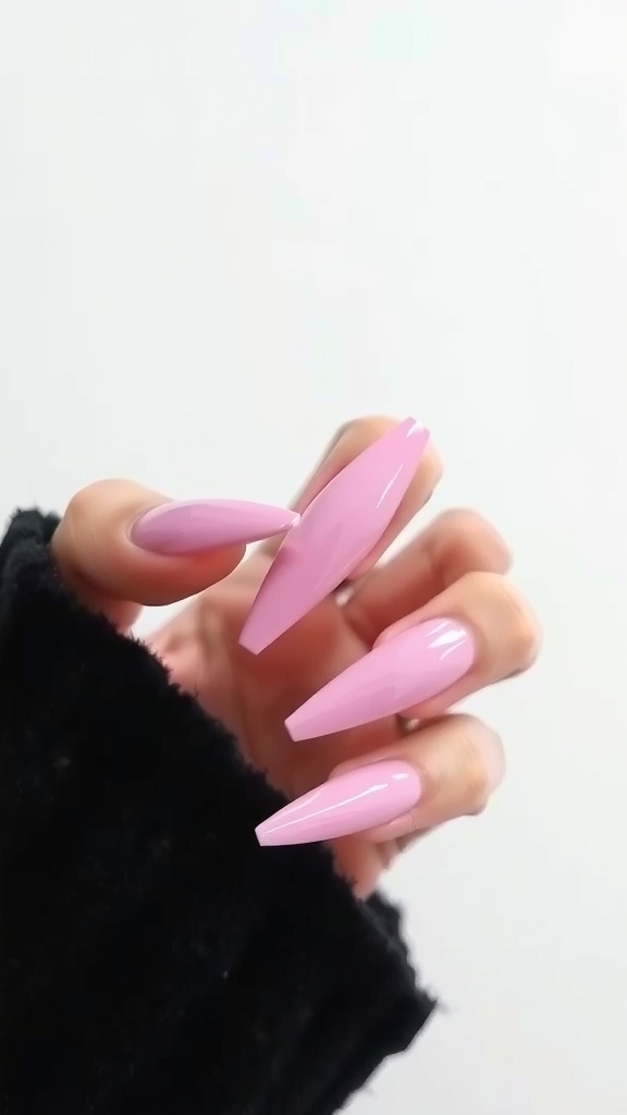 A hand with light pink chrome coffin nails, showcasing a stylish manicure.