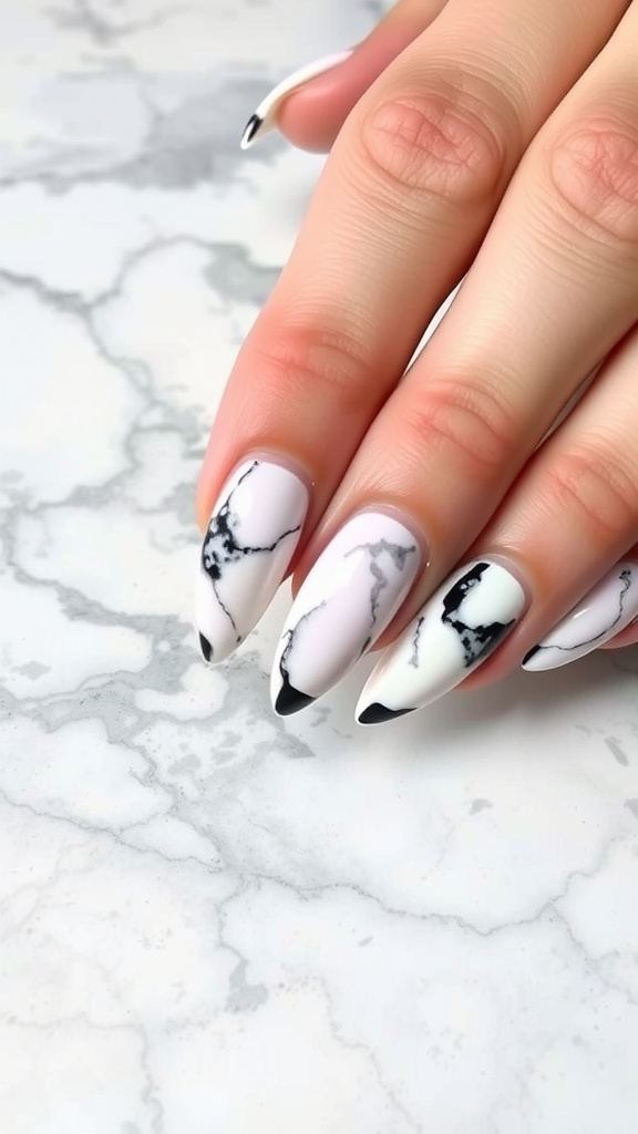 Close-up of almond-shaped nails with a marble effect design in white and black
