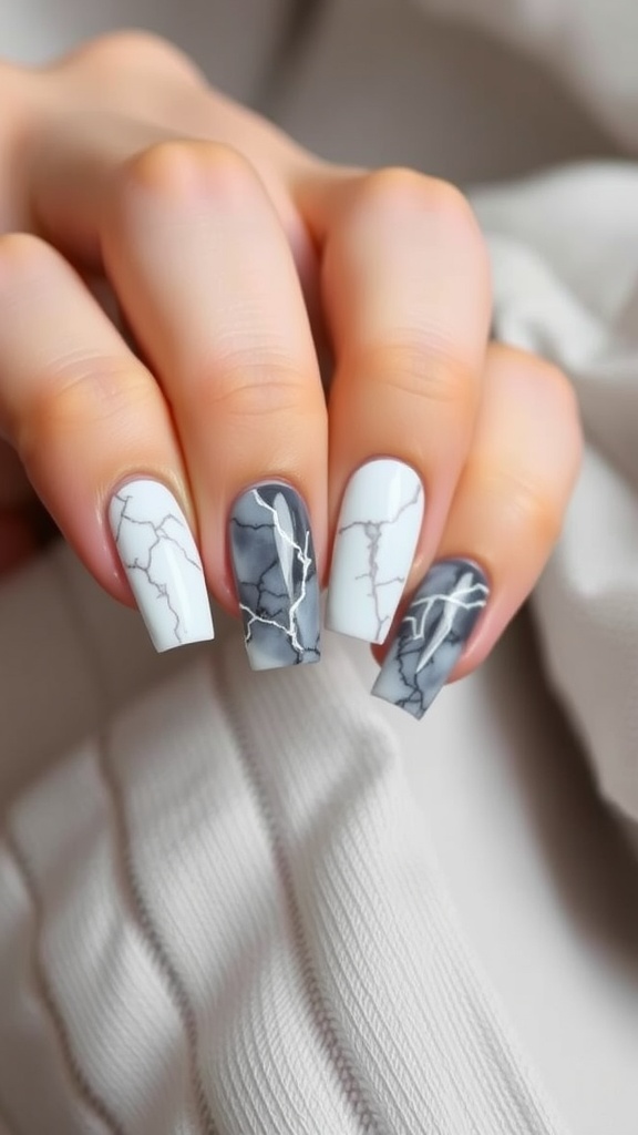 Square nails with a marble effect in white and gray, featuring intricate vein patterns.
