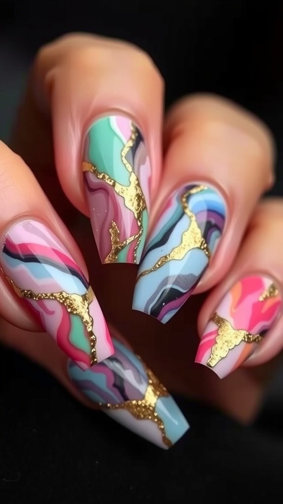 Colorful acrylic nails with a marble effect and gold accents.