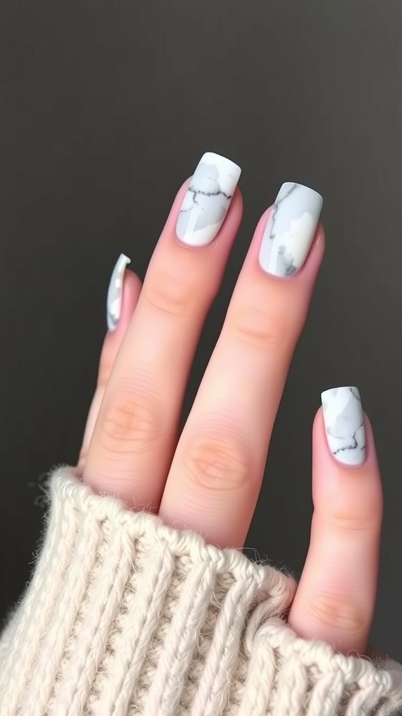 Nails with marble effect French tips in gray and white colors