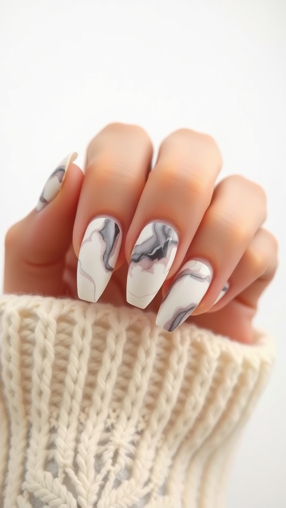 Nails with marble effect French tips in white, gray, and pink