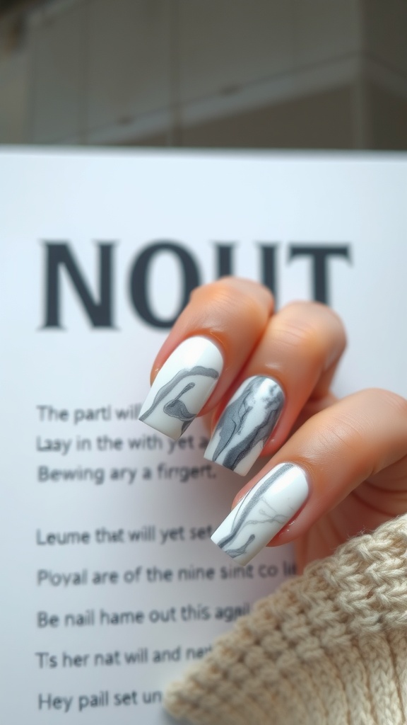 Nail art featuring a marble effect in white and gray colors