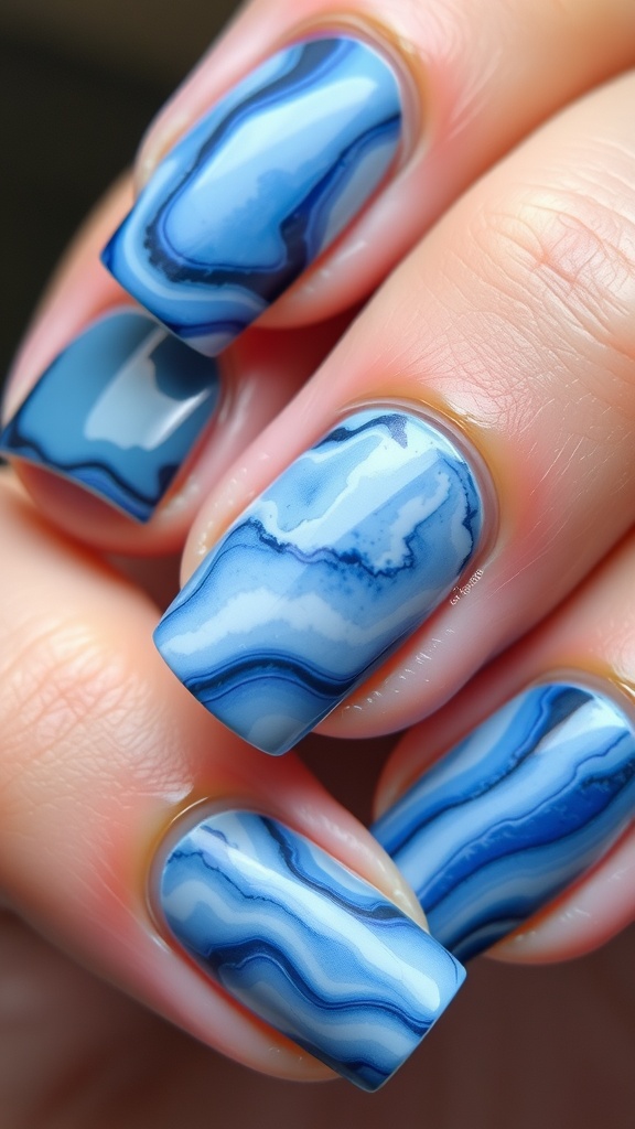 Nails showcasing a marble effect in light and dark blue shades