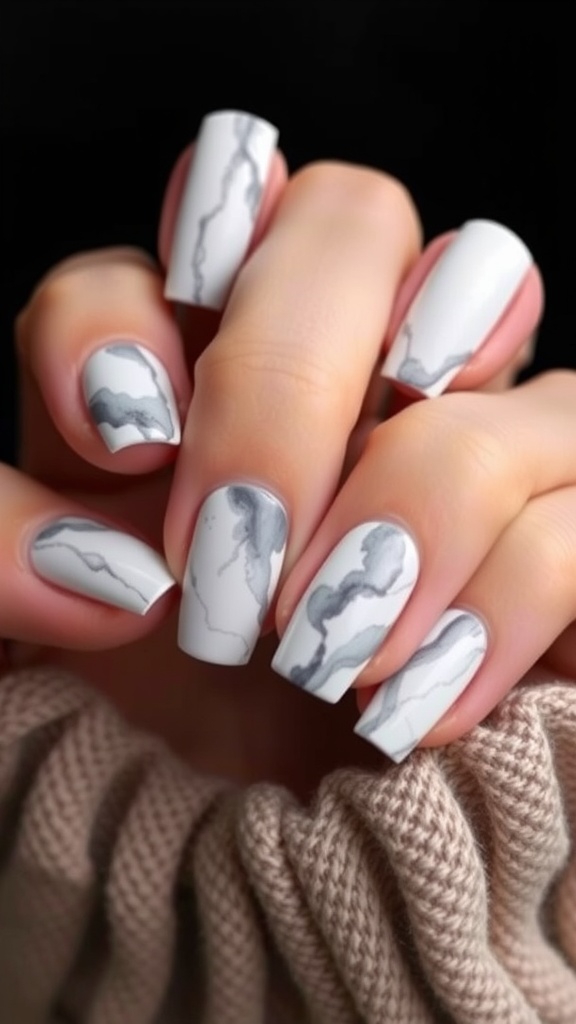A set of nails featuring a marble effect design in gray and white.