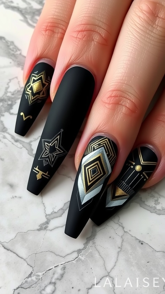 A close-up of matte black coffin-shaped nails with geometric designs in gold and silver.