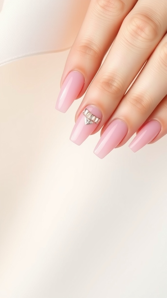 Close-up of pink chrome French tip nails with a jewel accent
