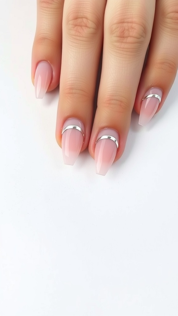 Light pink chrome nails with short length featuring silver chrome half-moons.