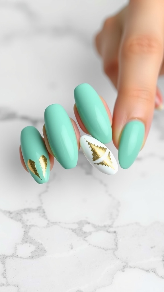 Mint green almond-shaped nails with gold accents