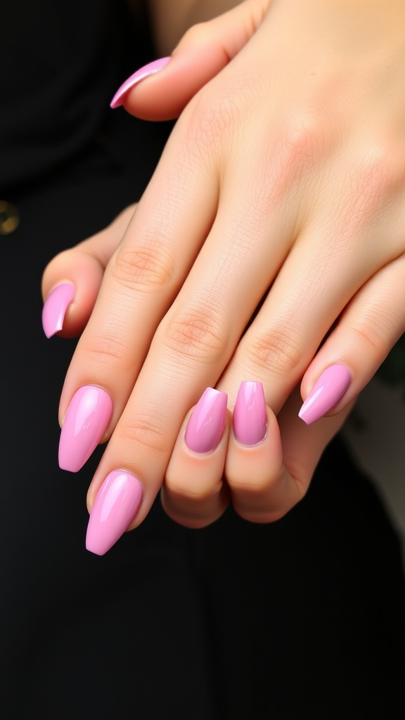 A close-up of beautifully manicured pink chrome nails in various shapes.