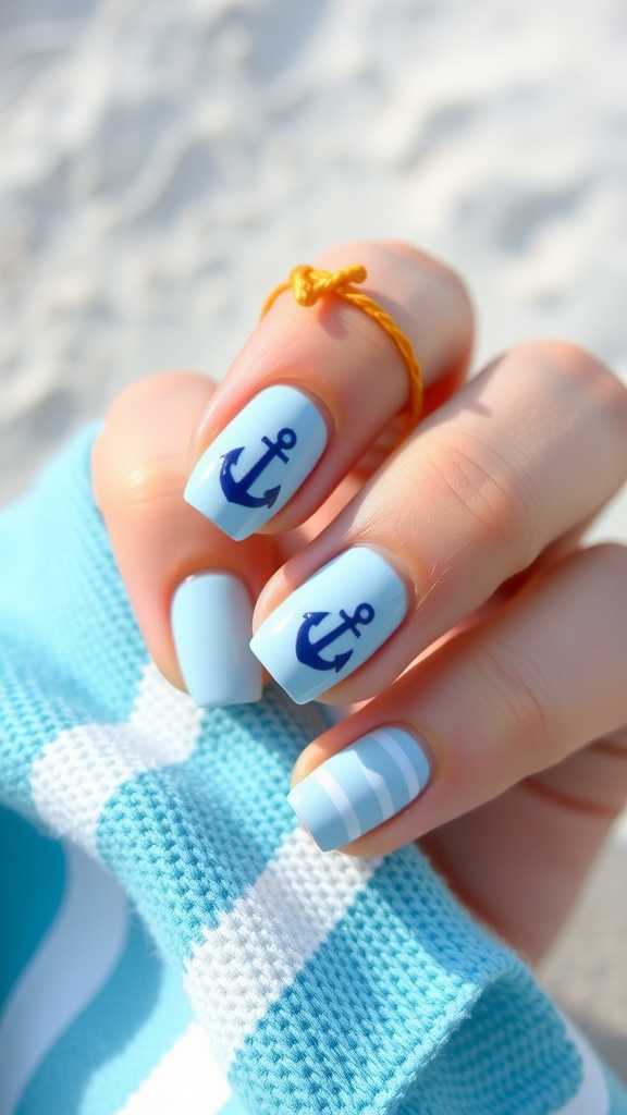 A hand with light blue nails featuring dark blue anchors and stripes, holding a blue and white striped fabric.