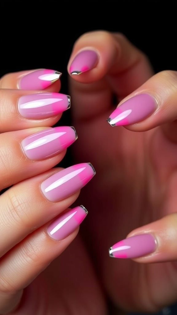Nails featuring pink French tips with chrome accents, showcasing a negative space design.