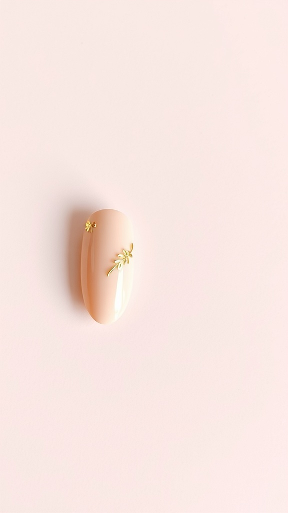 Nude almond nail with gold foil accents on a pink background.