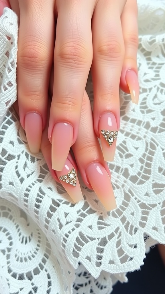 Close-up of nude coffin nails featuring rhinestones arranged in a triangle shape.