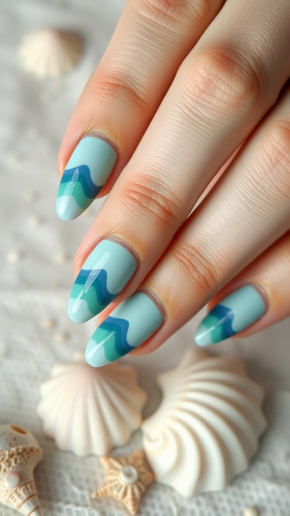 Close-up of hands with ocean-inspired nail art featuring blue and green waves on a light blue base, surrounded by seashells.