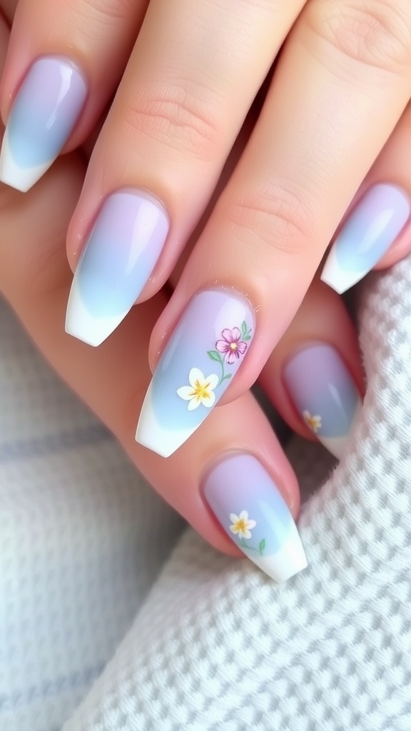 Light blue ombre nails with floral designs featuring pink and yellow flowers.