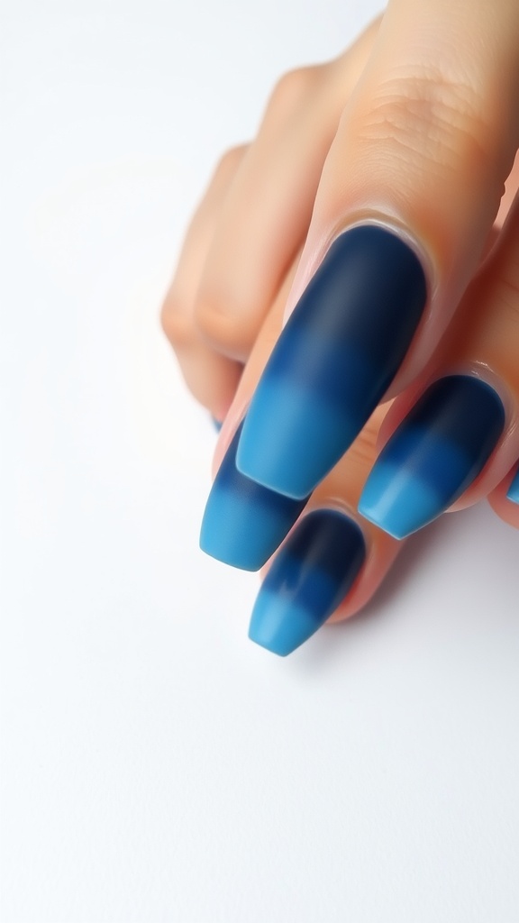 Ombre blue nail design with a gradient from dark to light blue