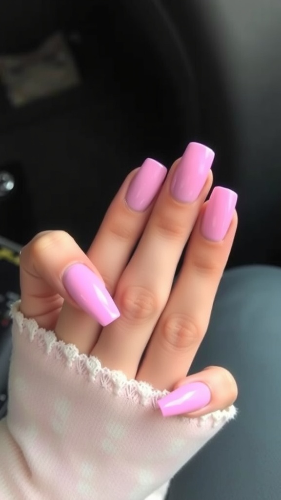 A set of ombre pink acrylic nails with a gradient effect, featuring glossy finishes.