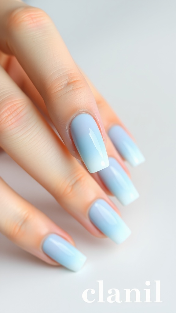 Beautiful pastel blue ombre nail art with a gradient effect from light blue to darker blue.
