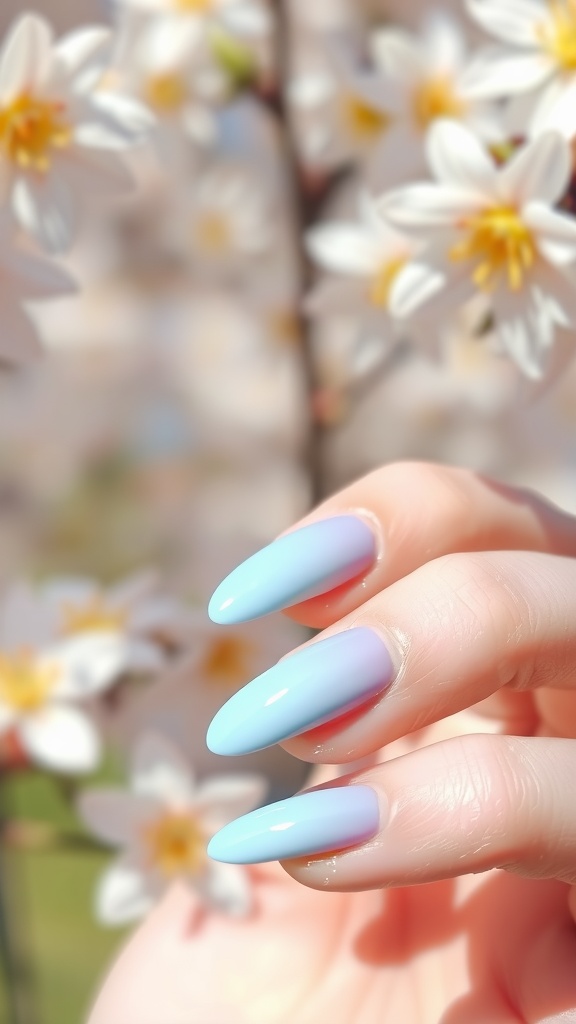 Pastel blue ombre nails against a backdrop of white flowers