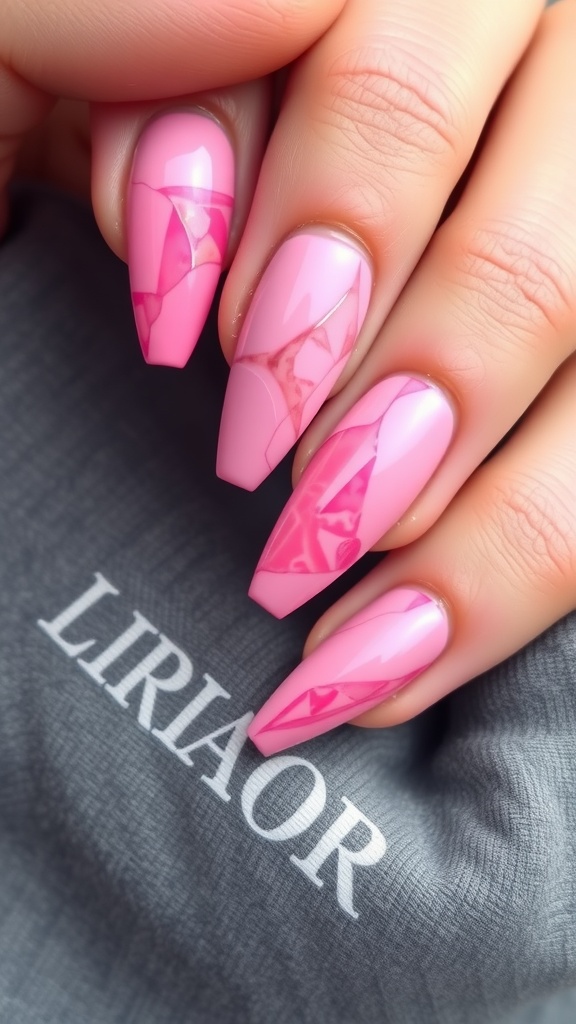 Close-up of hands with pink marble effect acrylic nails, featuring a mix of glossy and matte finishes.