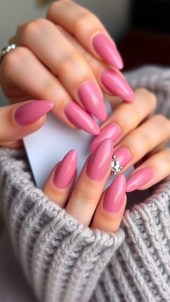 Rhinestone embellished pink almond-shaped nails displayed with a cozy sweater