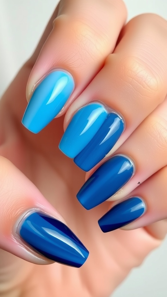 A set of nails featuring a sky blue ombre gradient, transitioning from light blue to dark blue.