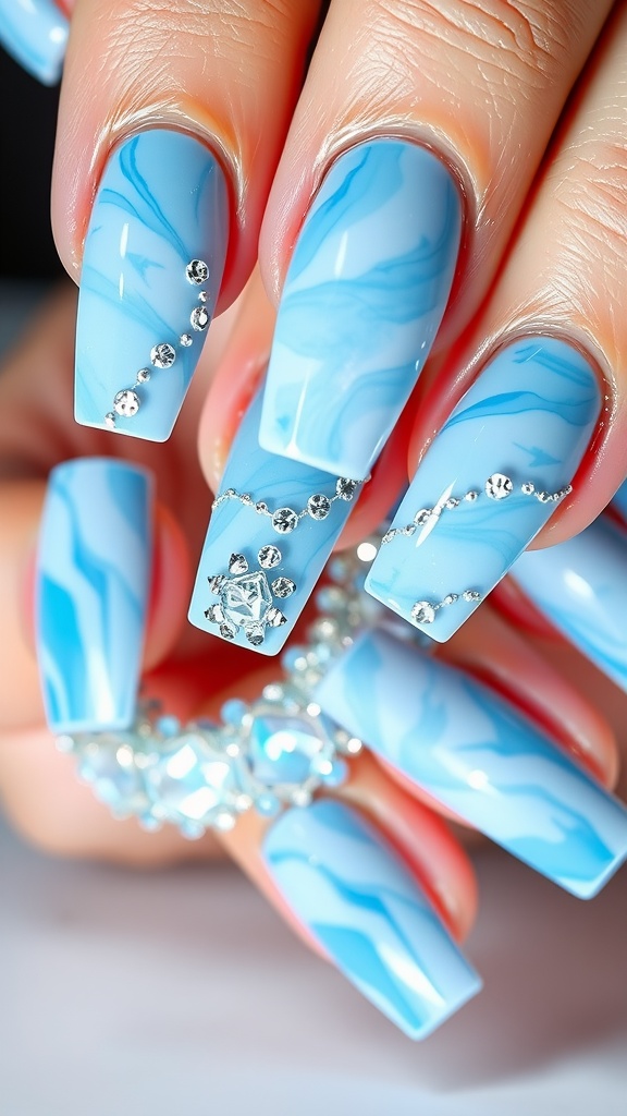 Close-up of light blue marble nails with sparkly accents and rhinestones