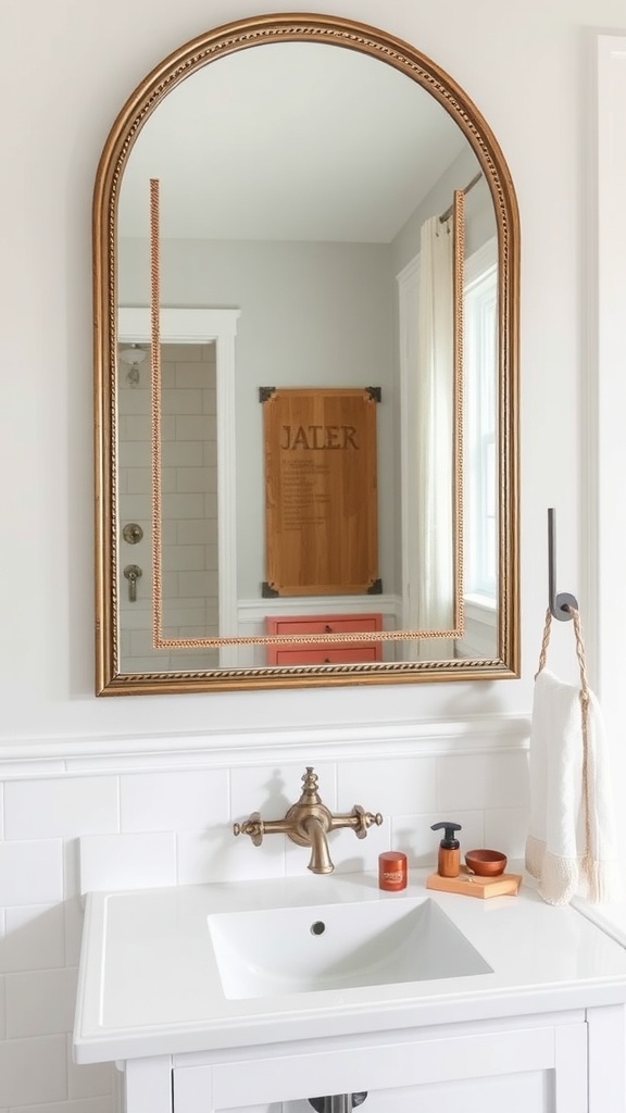 A modern farmhouse bathroom featuring a statement mirror with a golden trim above a white sink.