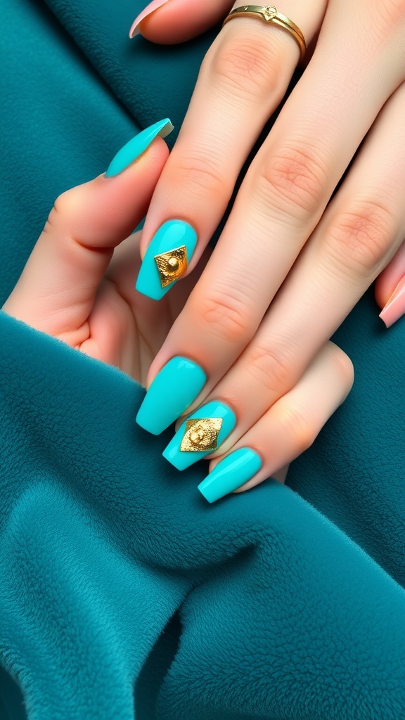 Close-up of turquoise nails with gold accents against a soft teal background