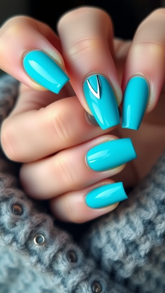 Turquoise blue nails with silver accents in a chic design.