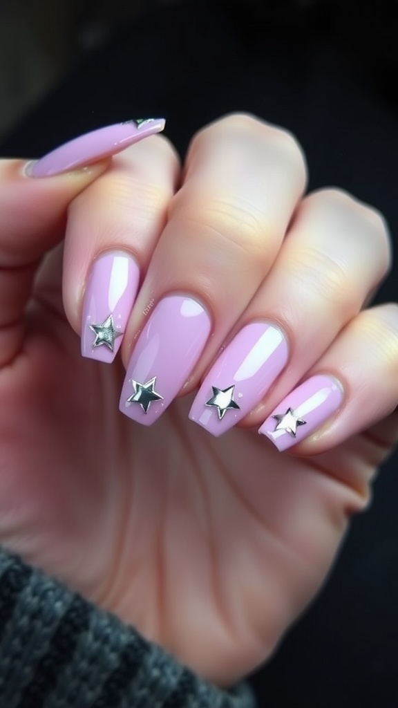 Nails featuring pink French tips with metallic star motifs.