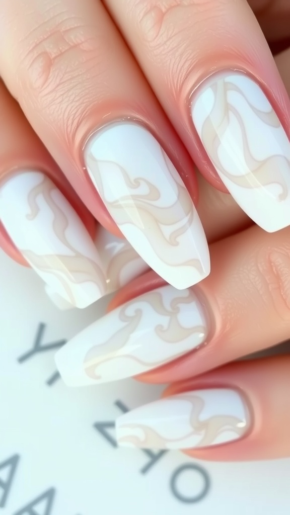 Close-up of white marble effect nails with soft beige swirls on a light background.