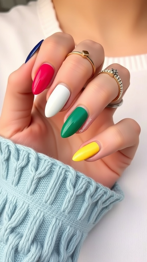 A hand with color block almond nails featuring pink, black, and white shades.