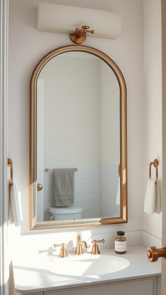 A modern bathroom featuring a stylish, arched mirror above a sink with golden fixtures and soft lighting.