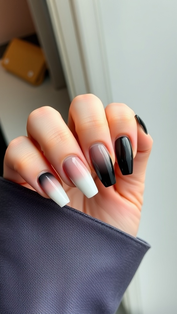 A hand showing nails with an ombre effect transitioning from white to black.