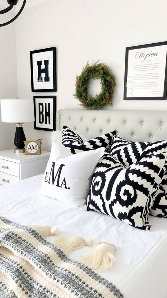 A stylish black, white, and grey bedroom featuring patterned pillows, a decorative wreath, and framed art.