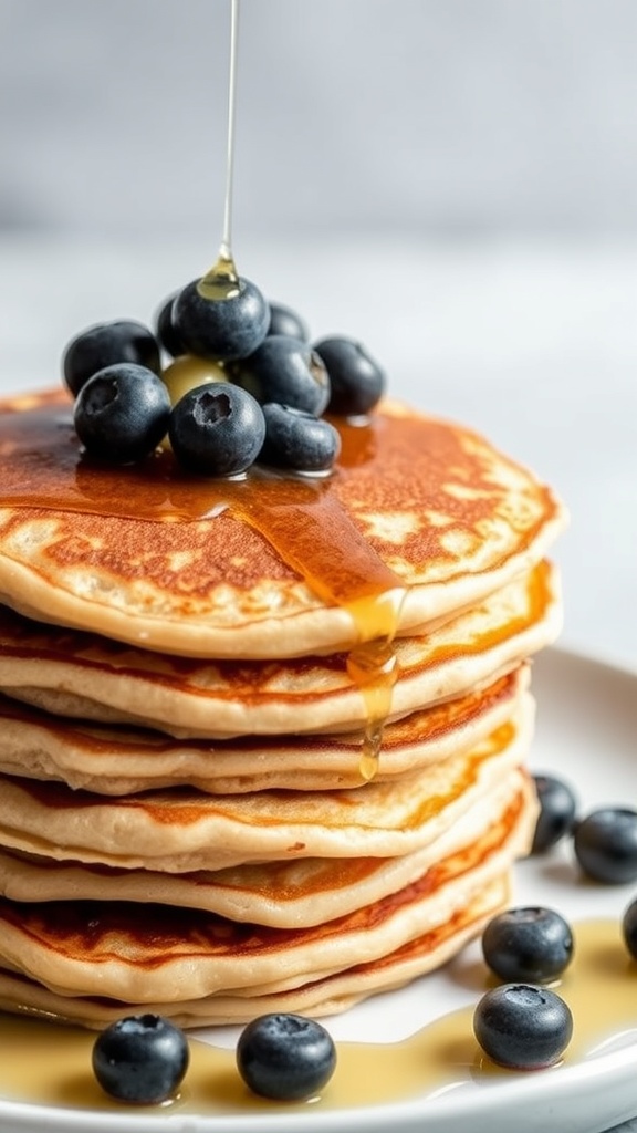 A stack of fluffy pancakes topped with blueberries and syrup.