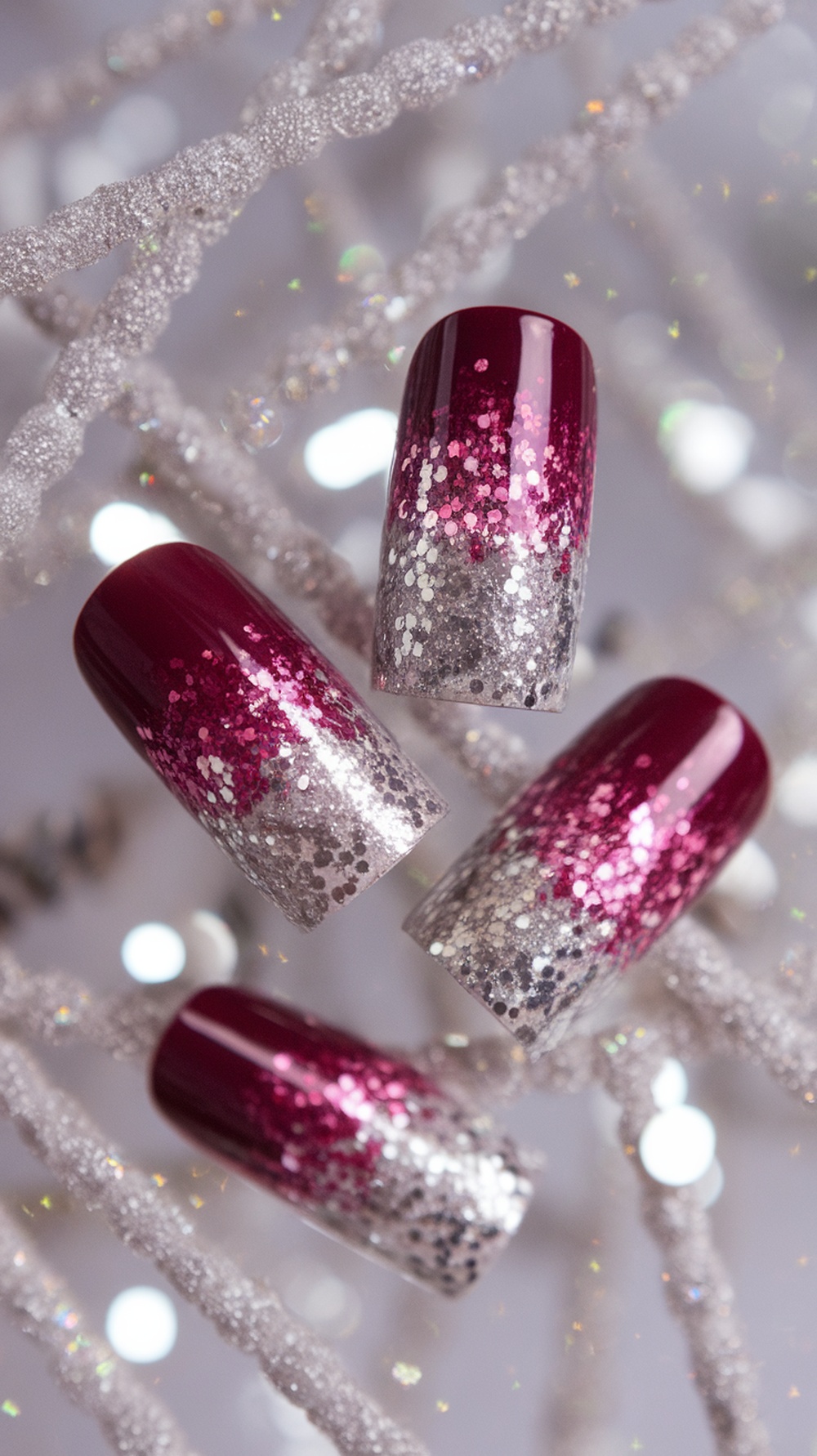 Burgundy nails with a silver glitter fade design