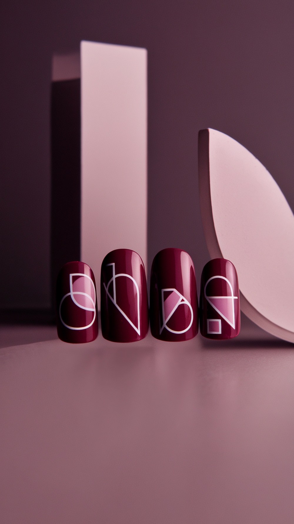 Burgundy nails with geometric shapes in white