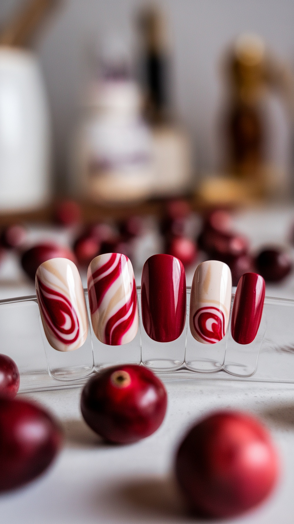 Nail designs featuring cranberry and cream swirls on display.
