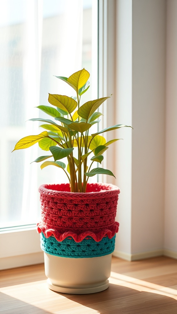 Colorful crochet plant pot cover in red and teal with a green plant inside, placed by a window.