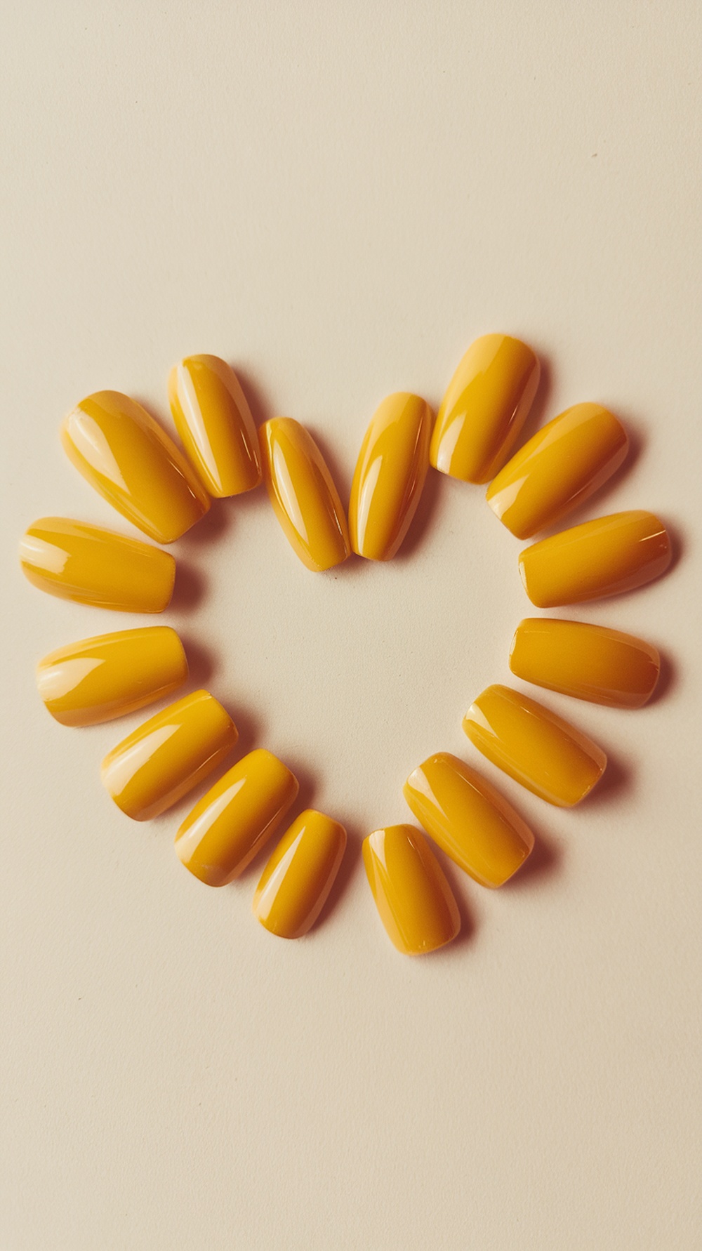 A heart shape made of various yellow nail designs.