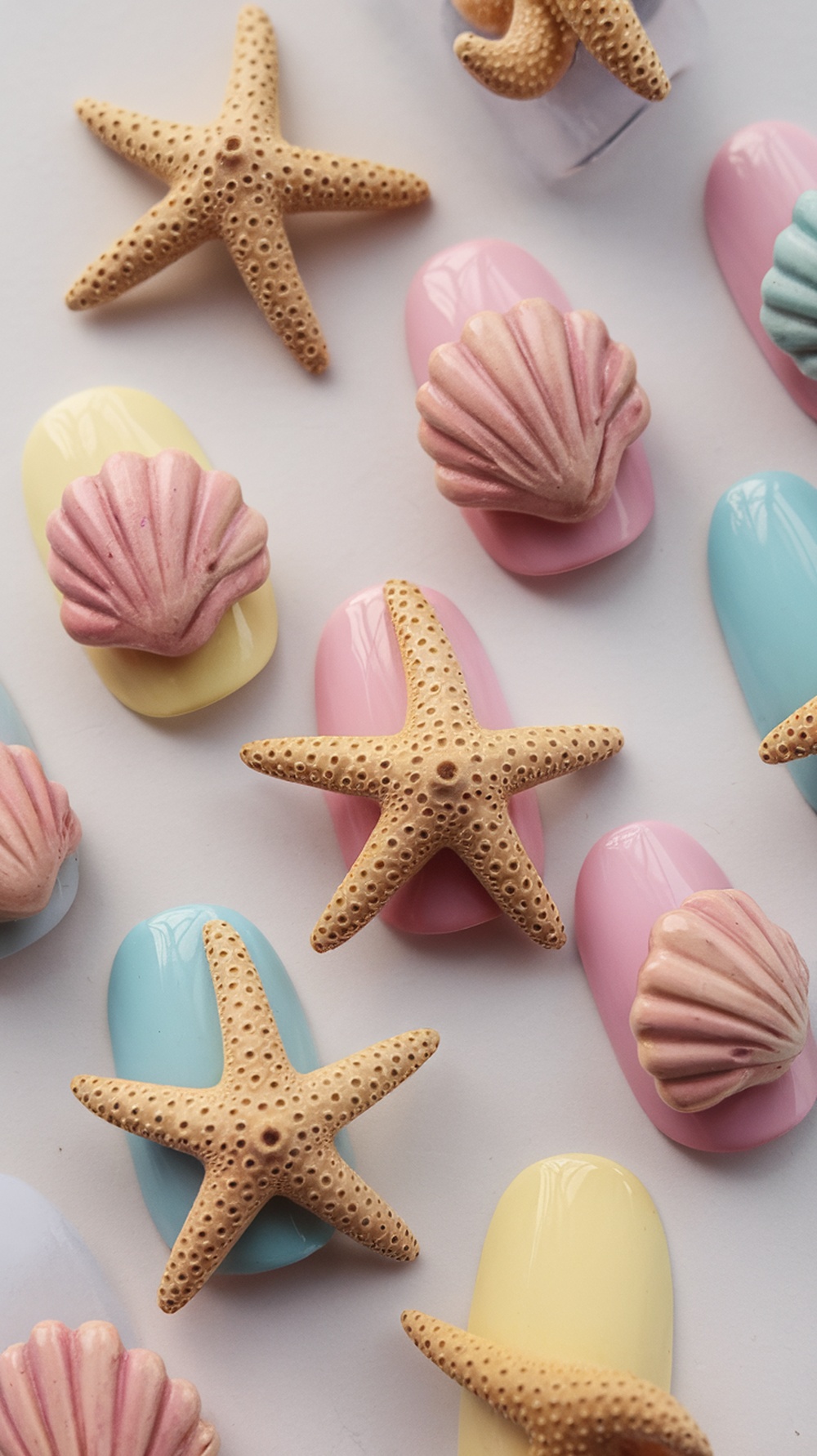 Colorful summer nail designs featuring starfish and seashells