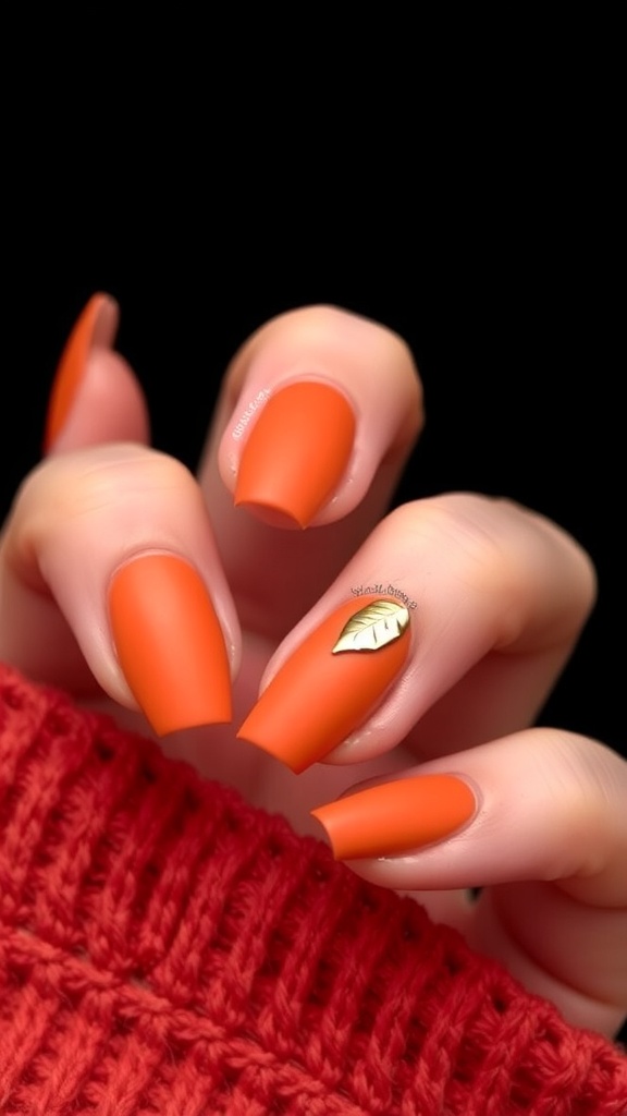 Burnt orange matte nails with gold leaf foil accents