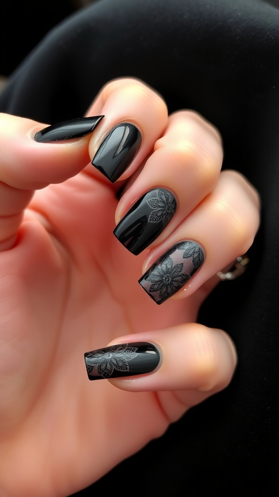 A hand showing gothic lace accent nails with a mix of matte black and glossy finishes.