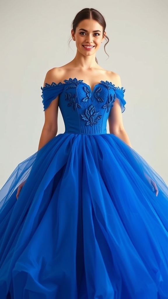 A model wearing a royal blue ball gown with a corset bodice and off-shoulder design, featuring floral embroidery and a flowing tulle skirt.