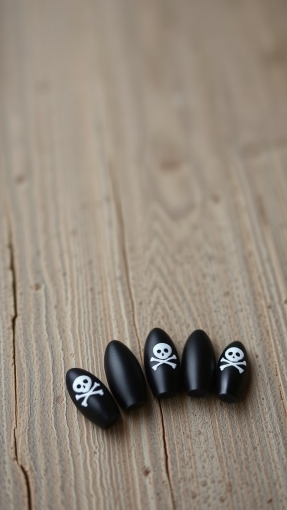 Matte black nails with white skull and crossbones designs