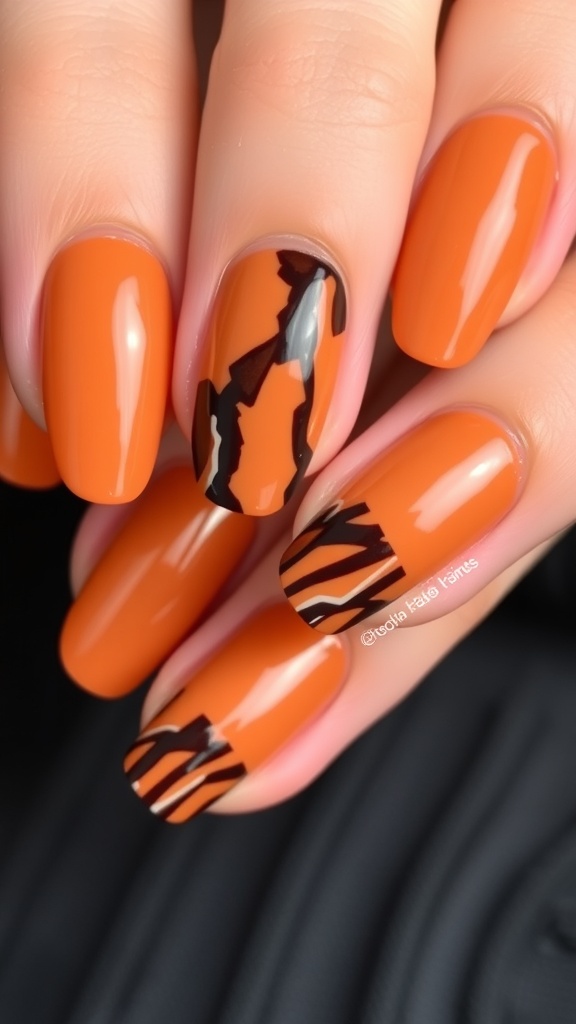 Close-up of tortoise shell accent nails featuring orange and black patterns.