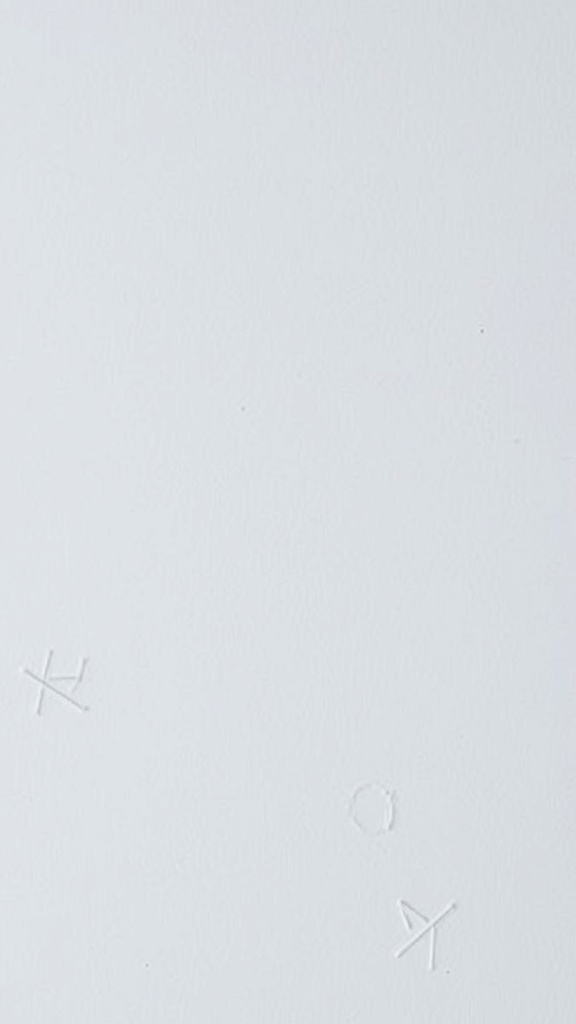 A close-up of a minimalist white background with subtle markings.